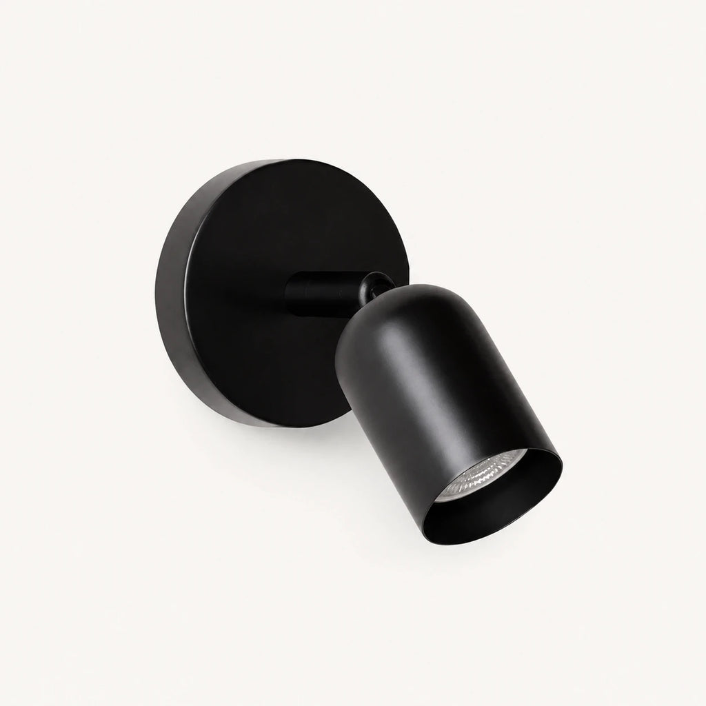 Adjustable spot LED Nordic wall light in black — a sleek directional wall spotlight for reading and task lighting.