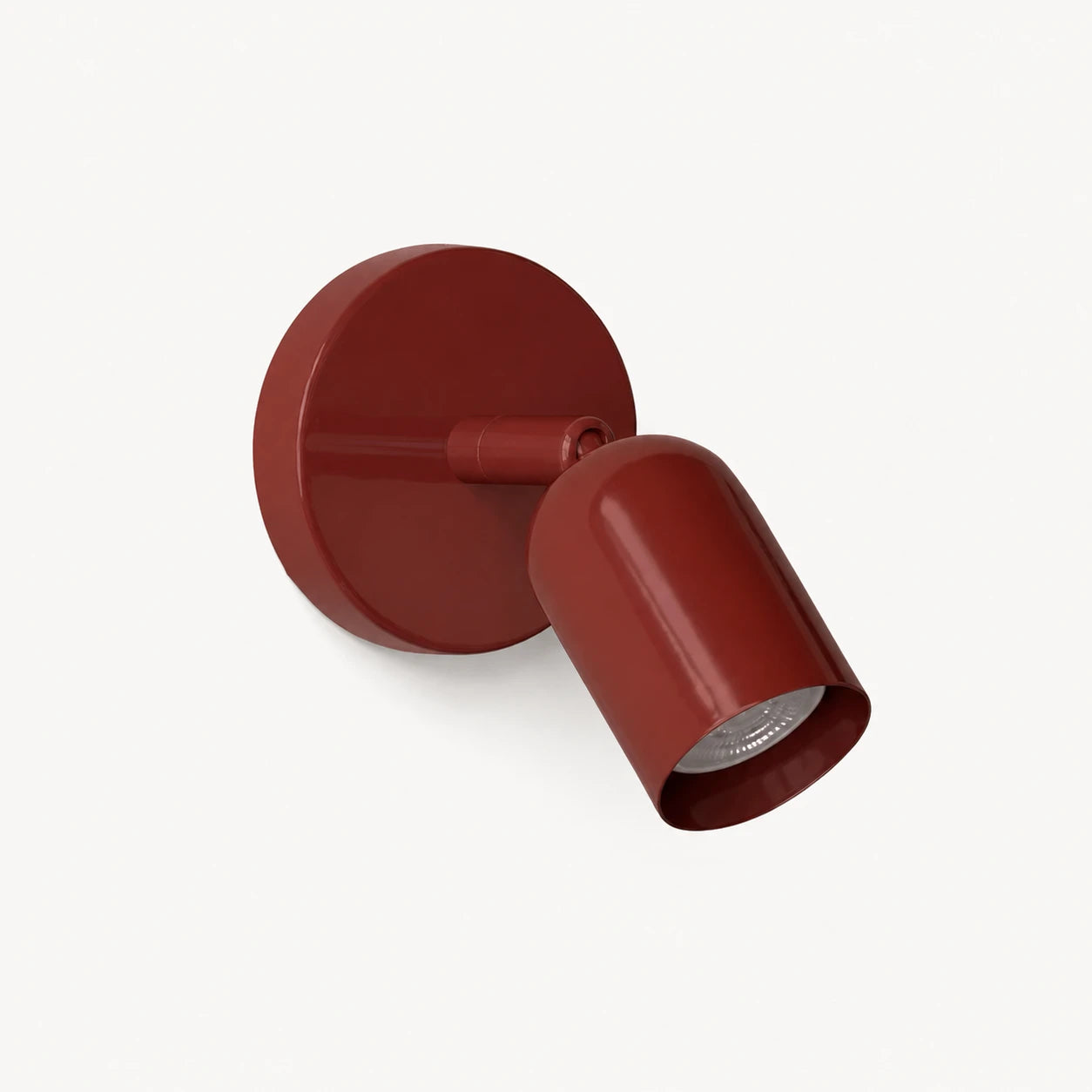 Adjustable spot LED Nordic wall light in red — a bold directional wall spotlight for eclectic and maximalist interiors.