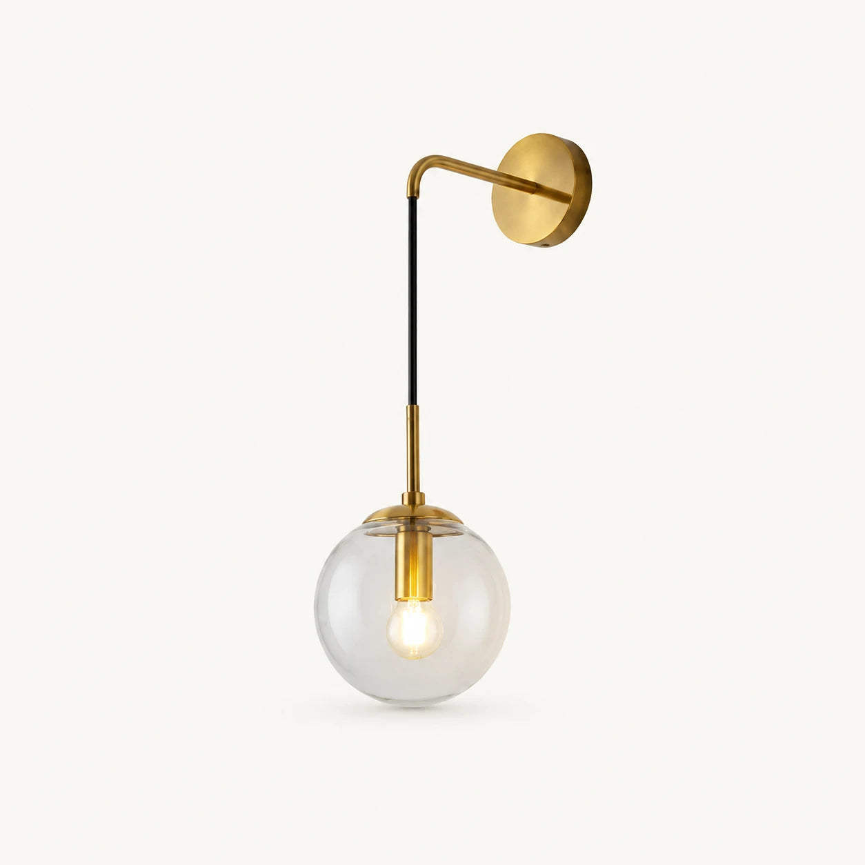 Gold amber glass hook arm Nordic wall sconce with clear glass globe and brushed gold hook arm hardware detail view