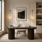 Gold clear amber glass hook arm Nordic wall sconces flanking framed abstract art above wooden desk in panelled home office