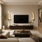 Pair of black crescent arc LED wall lights flanking a wall-mounted TV in a warm modern living room