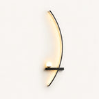 Black crescent arc LED bedside wall light in right-facing orientation — arc curves toward the centre of the bed.