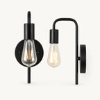 All-black bare bulb industrial wall sconce with matte black arm and socket holding Edison globe light bulb detail