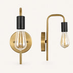Gold and black bare bulb industrial wall sconce with gold arm and black socket holding Edison globe bulb detail