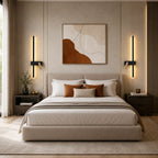 Pair of black LED strip spotlight bedside wall lights beside a bed with terracotta bedding in a modern bedroom