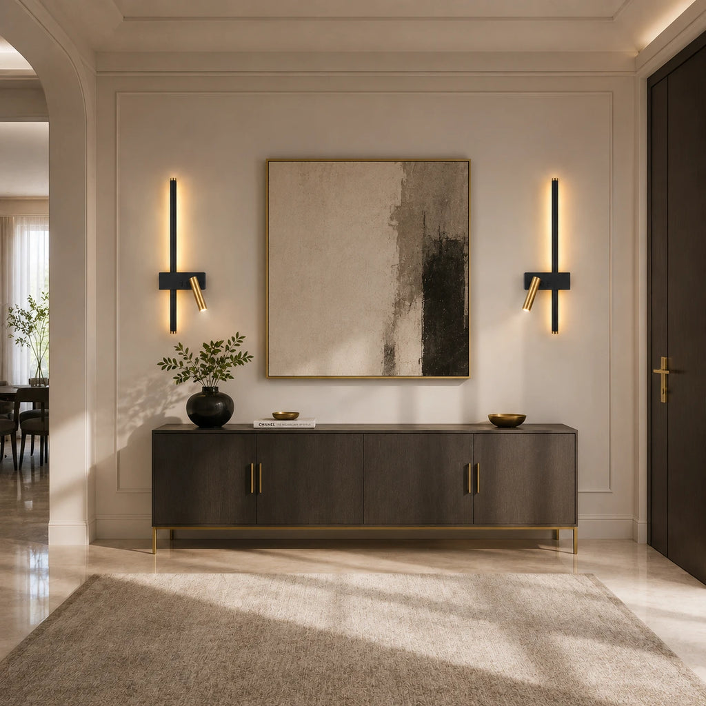 Pair of black LED strip spotlight wall lights flanking a sideboard and artwork in a grand entrance hallway