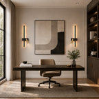 Black LED strip spotlight wall lights flanking a desk and bookshelf in a sophisticated home study