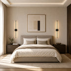 Pair of black rechargeable wireless minimalist wall lights either side of a bed in a calm neutral bedroom
