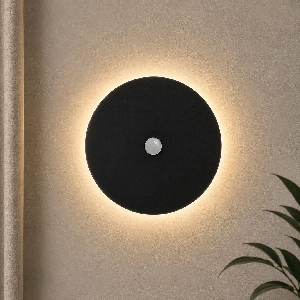 Black halo motion sensor LED modern wall light — black version with motion sensor activated.