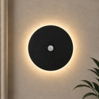 Black halo motion sensor LED modern wall light — black version with motion sensor activated.