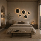 White halo LED wall light mounted in a bedroom, glowing softly as ambient accent lighting on a neutral painted wall.