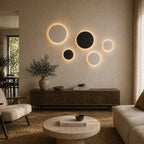 Black halo motion sensor LED wall light on a painted brick hallway wall, activating automatically as you pass.