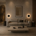 White halo LED wall light in a living room, providing warm circular ambient glow as subtle decorative wall lighting.