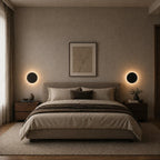 Black halo LED wall light on a white porch wall, automatically lighting the entrance when motion is detected.