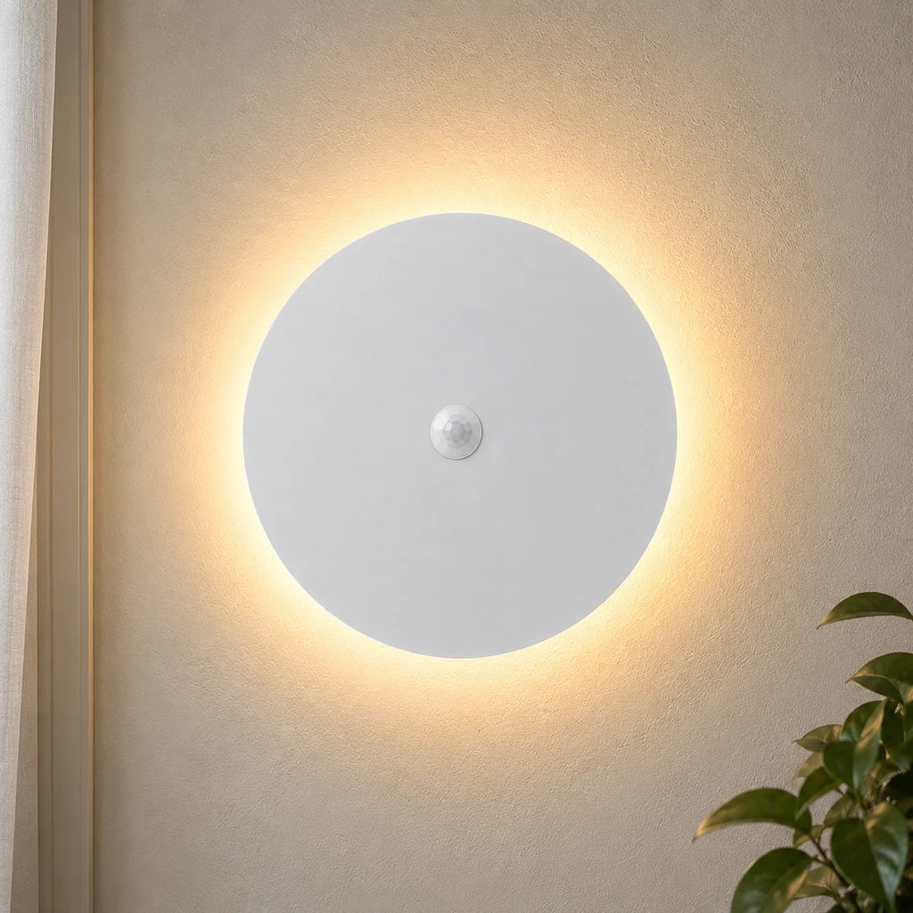Black halo motion sensor LED modern wall light — white version with motion sensor activated.