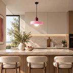 Coloured Glass Bauhaus Pendant Light in Pink glass and Red fitting installed above furniture in a kitchen setting.