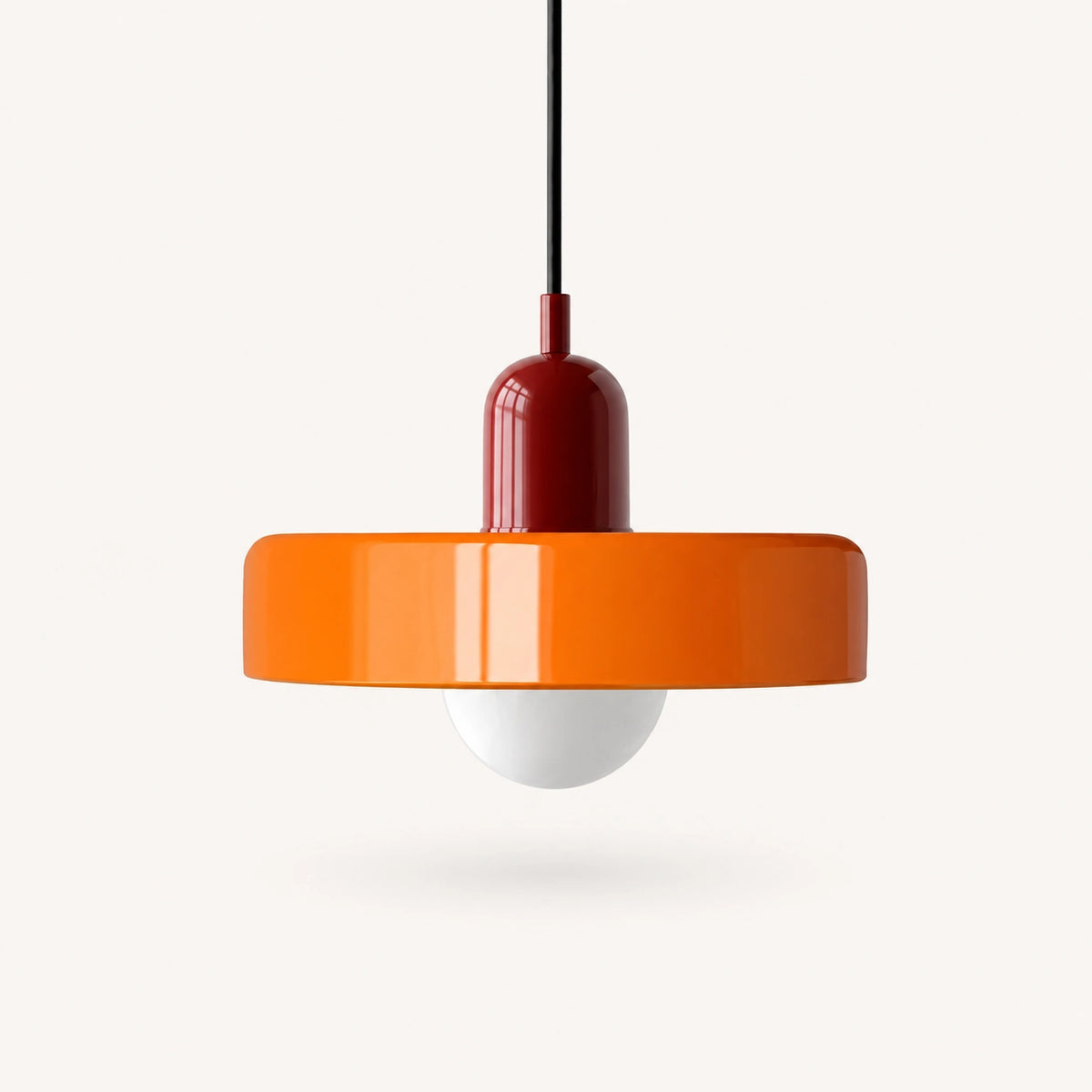 Coloured Glass Bauhaus Pendant Light shown in Orange glass and Red fitting, highlighting the compact pendant shape and finish.