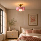 Coloured Glass Bauhaus Semi-Flush Ceiling Light in Pink glass and Gold fitting installed above furniture, alternate lifestyle view.