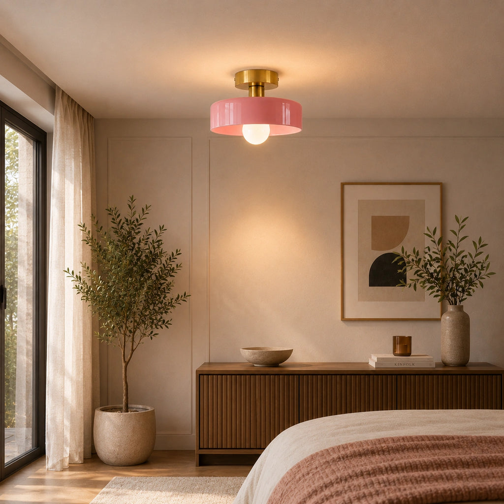 Coloured Glass Bauhaus Semi-Flush Ceiling Light in Pink glass and Gold fitting installed above furniture in a bedroom setting.