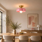 Coloured Glass Bauhaus Semi-Flush Ceiling Light in Pink glass and Gold fitting installed above furniture in a dining room setting.