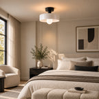 Coloured Glass Bauhaus Semi-Flush Ceiling Light in White glass and Black fitting installed above furniture in a bedroom setting.