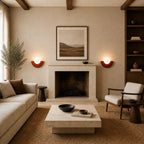 Pair of Colourful Glass Globe Nordic Wall Lights in red flanking a stone fireplace in a Nordic living room
