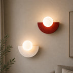 Two Colourful Glass Globe Nordic Wall Lights in red and white in a warm minimal Nordic living room