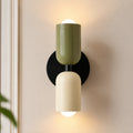 Colourful Nordic indoor wall light — green and white cylindrical shades on a black backplate for a bold two-tone look.
