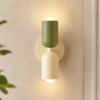 Colourful Nordic indoor wall light — green and white cylindrical shades on a cream backplate for a soft natural Scandinavian look.