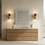 Pair of red and pink Nordic indoor wall lights above a bedroom dresser, eliminating table lamp clutter from surfaces.
