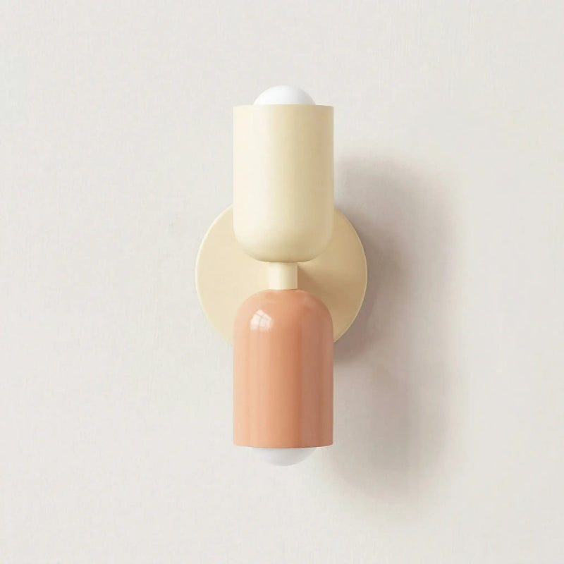 Colourful Nordic indoor wall light — white and pink cylindrical shades on a cream backplate for a soft pastel bedroom look.