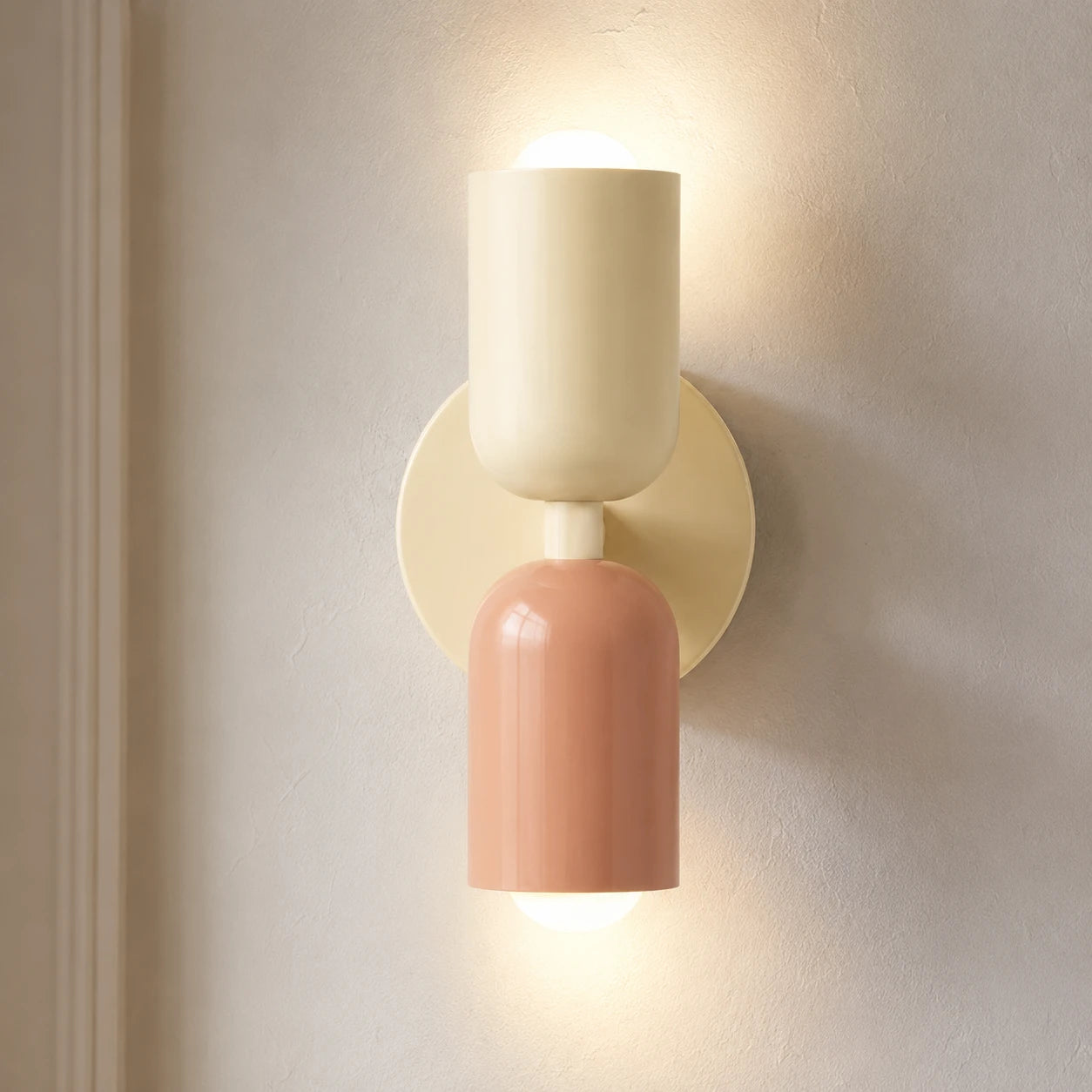 Colourful Nordic indoor wall light — white and pink cylindrical shades on a cream backplate for a soft pastel bedroom look.