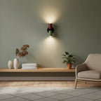 Sage green living room with wooden shelf and beige armchair after installing the colourful Nordic up and down wall light