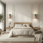 Pair of colourful Nordic metal wall lights with green and pink cylindrical shades mounted as bedside wall lights in a Scandinavian bedroom