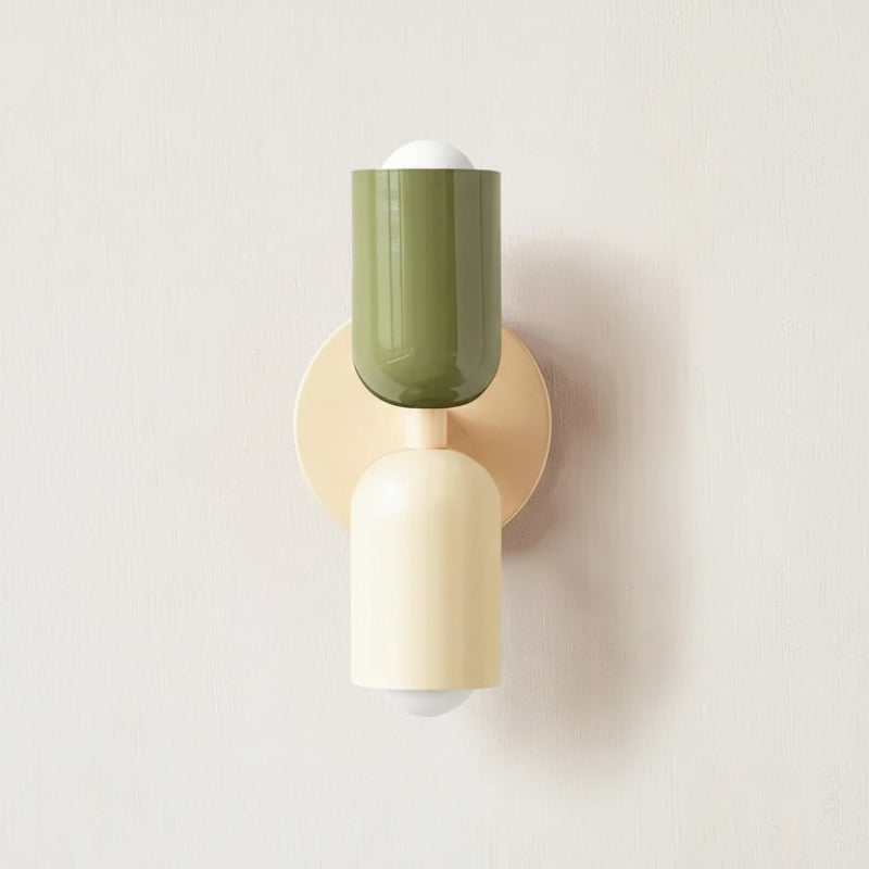 Colourful Nordic metal wall light with two cylindrical shades in green and white on a cream base, casting light up and down
