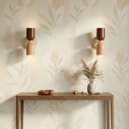 Pair of colourful Nordic metal wall lights with red and pink cylindrical shades on cream bases, casting warm ambient light in a hallway