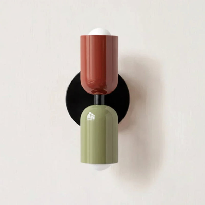 Colourful Nordic metal wall light with two cylindrical shades in red and green on a black base, casting light up and down