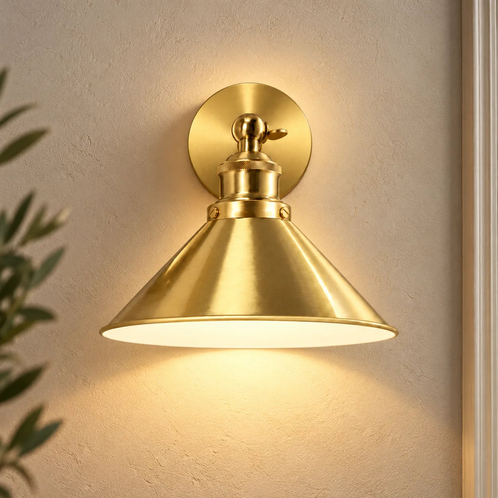 Gold cone arm industrial wireless wall sconce shown from the front, highlighting its slim swing arm and cone shade design.