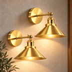 Gold cone arm industrial wall sconce mounted with its swing arm extended, directing a warm rechargeable RGB glow downward.