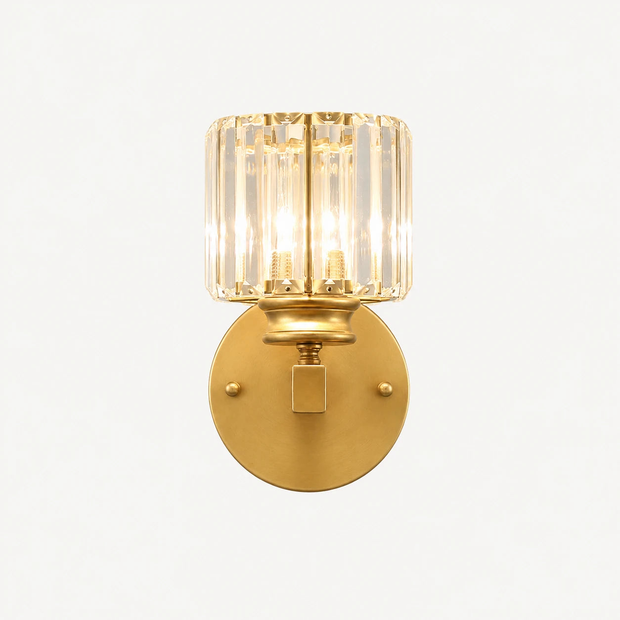 Gold crystal cylinder Art Deco wall sconce front view showing faceted crystal cylinder shade and brushed gold arm