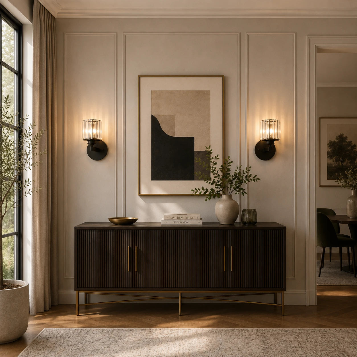 Black crystal cylinder Art Deco wall sconces flanking framed artwork above dark sideboard console in elegant living room