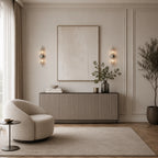Silver column crystal glass Art Deco wall sconces flanking artwork above sideboard console in bright minimalist living room
