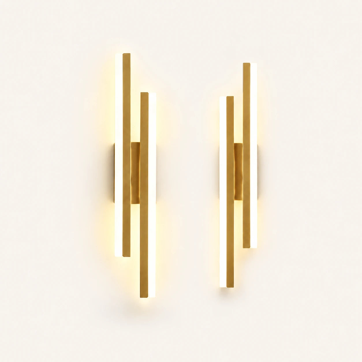 Double strip LED modern wall light in gold as a matched left and right pair for a double bed.