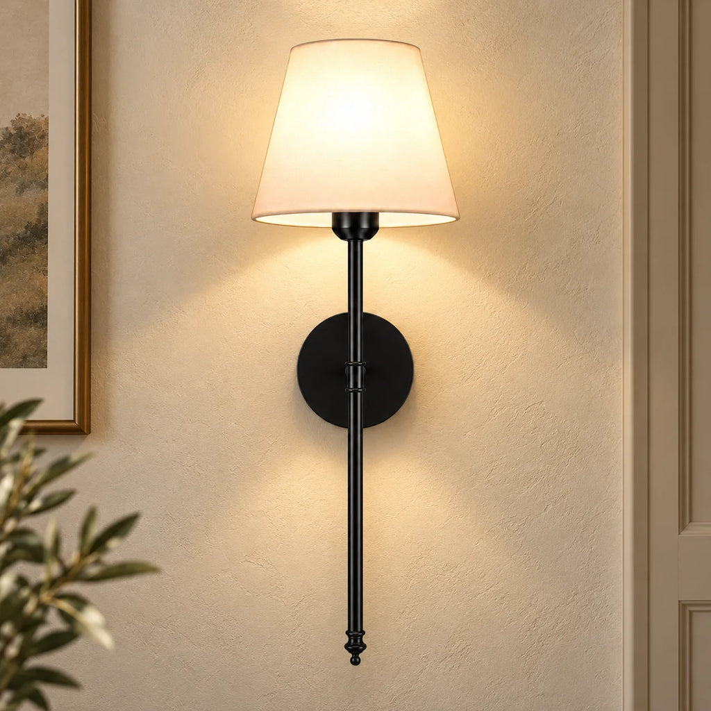Black fabric mid-century wireless wall sconce mounted on the wall, featuring a tapered fabric shade on a slim metal stem.