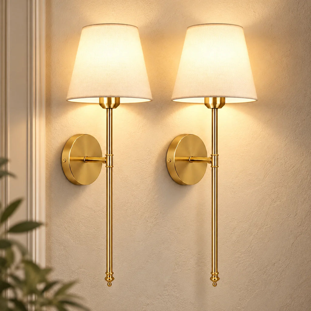 Pair of gold fabric mid-century wireless wall sconces mounted together, each with a tapered fabric shade on a slim stem.