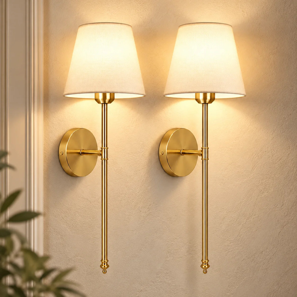 Pair of gold fabric mid-century wireless wall sconces mounted together, each with a tapered fabric shade on a slim stem.