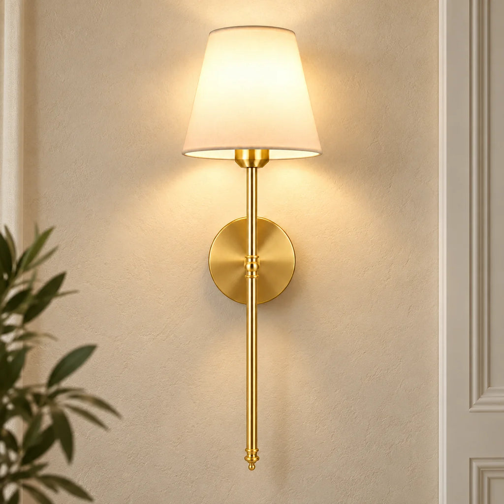 Gold fabric mid-century wireless wall sconce mounted on the wall, featuring a tapered fabric shade on a slim metal stem.