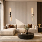 Black geometric two-bar LED wall lights beside a sectional sofa in a modern living room with fluted wall panel