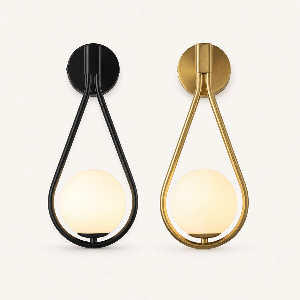 Glass loop arm Nordic wall sconce shown in black and gold finish options with white opal globe shade