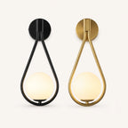 Glass loop arm Nordic wall sconce shown in black and gold finish options with white opal globe shade